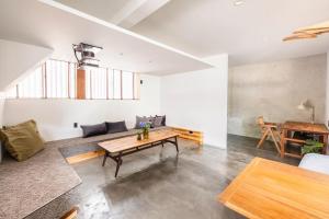 a living room with a table and a couch at BLIKIYA Doma in Fujiyoshida