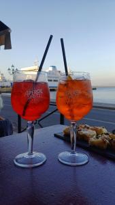 a couple of glasses sitting on a table at LV SWAN Apartment in Carloforte