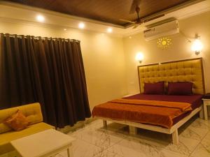 a bedroom with a bed and a couch at Leaf Garden Retreat in Varkala +15 photos