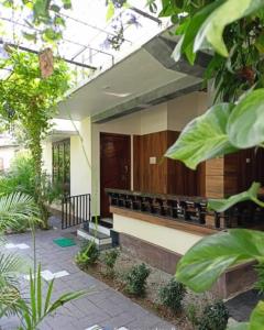 a building with a row of benches in a courtyard at Leaf Garden Retreat in Varkala