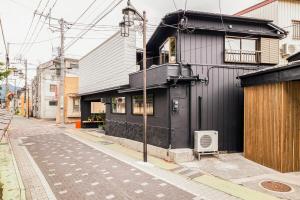 a black building on the side of a street at BLIKIYA Doma in Fujiyoshida