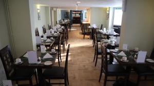 a row of tables and chairs in a restaurant at Centennial Hotel in Cambridge