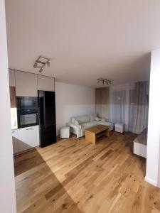 a large living room with a couch and a table at Apartament Lubawka in Lubawa