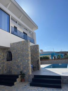 a view of a house with a stone wall at Villa Kociu in Ksamil