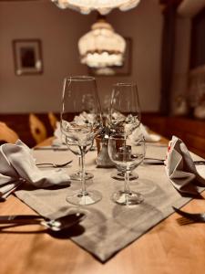 a table with wine glasses on top of it at Hotel Tannenhof in Egmating +16 photos