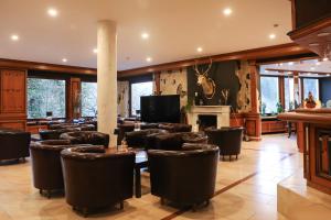 a restaurant with tables and chairs and a fireplace at Schwaben Resort Ebnisee in Ebni