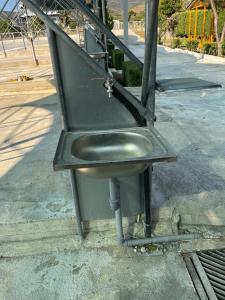 a metal sink sitting on the side of a street at Caco Camper Parking in Berat