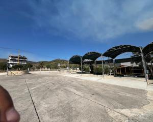 an empty parking lot with a basketball court at Caco Camper Parking in Berat