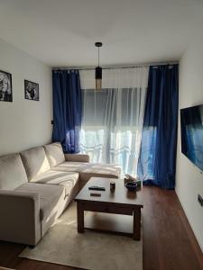 a living room with a couch and a coffee table at Modern 4 stars Apartment with terace & free parking in Šibenik