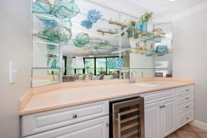 a bathroom with a sink and a large mirror at Phoenix on the Bay 1124 in Orange Beach