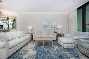 a living room with a couch and a table at Phoenix on the Bay 1124 in Orange Beach