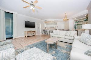 a living room with white furniture and a flat screen tv at Phoenix on the Bay 1124 in Orange Beach +38 photos