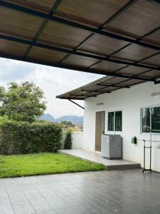 an outdoor patio with a refrigerator in a yard at Cheeva Home #1 in Ban Pa Tung (7)
