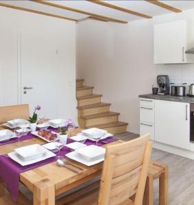 a dining room table with a purple table cloth at Ferienwohnung Leppert in Schwanau