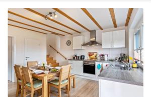 a kitchen with a table and chairs in a room at Ferienwohnung Leppert in Schwanau +13 photos