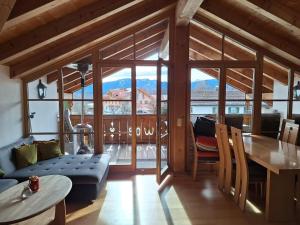 a living room with a table and a dining room at Streidlhof in Lenggries