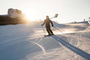 a person is skiing down a snow covered slope at Apartament Lubawka in Lubawa