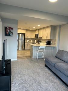 a living room with a couch and a kitchen at Authentic Suite in YYC +13 photos