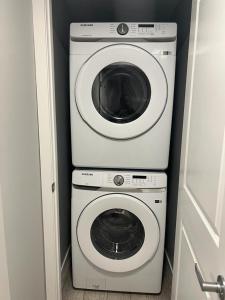 a washer and dryer in a small room at Authentic Suite in YYC