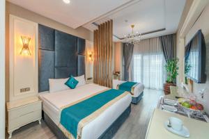 a hotel room with two beds and a desk at Marnas Hotels in Istanbul +50 photos