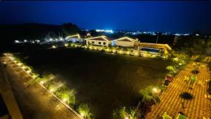 an aerial view of a house at night with lights at Camp Leo Aaranya Resort in Sasan Gir +1 photo