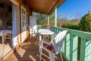 a porch with a table and chairs on it at Chalet 2 FLAMANT ROSE in Roquebrune-sur-Argens