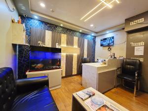 a large room with a fish tank on the wall at hotel Prime Plaza Newtown in kolkata +30 photos