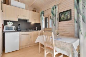 a small kitchen with a table and a microwave at Chalet 2 FLAMANT ROSE in Roquebrune-sur-Argens