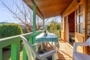 a table and chairs on the porch of a house at Chalet 2 FLAMANT ROSE in Roquebrune-sur-Argens