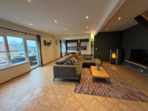 a living room with a couch and a table at Happy Duplex in Jalhay