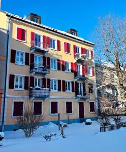a large building with colorful windows in the snow at La Maison de Jacob in La Chaux-de-Fonds