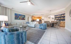 a living room with a couch and a table at Phoenix on the Bay 1328 in Orange Beach +41 photos