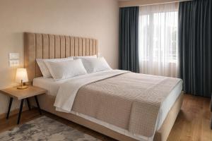 a bedroom with a large bed and a window at Vila Eva in Golem