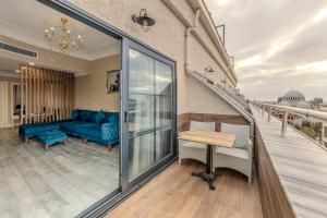a balcony with a blue couch and a table at Marnas Hotels in Istanbul