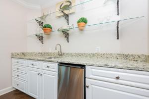 a kitchen with white cabinets and a sink at Phoenix on the Bay 1109 condo in Orange Beach