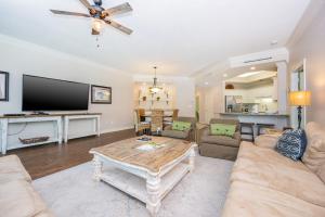 a living room with a couch and a table at Phoenix on the Bay 1109 condo in Orange Beach +38 photos