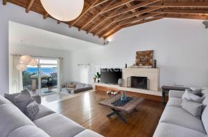 a living room with a couch and a fireplace at TEKCE Villa Mae N3 in Yeniköy