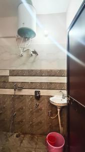 a bathroom with a sink and a light on the wall at Royal guest house in Gorakhpur