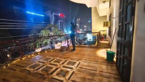 a person standing on a balcony at night at Royal guest house in Gorakhpur