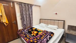 a small bedroom with a bed and a curtain at Royal guest house in Gorakhpur