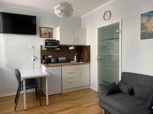 a living room with a table and a kitchen with a couch at Apartment in der Eifel in Blankenheim