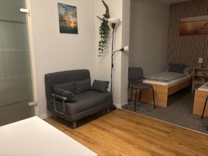 a living room with a chair and a couch at Apartment in der Eifel in Blankenheim +1 photo