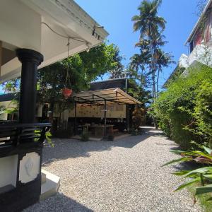 a patio with an umbrella on a building at Mad about Coco Yoga & Beach Retreat in Varkala