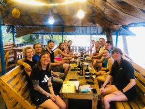 a group of people sitting at a table in a restaurant at Villa Mango in Negombo