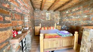 a bedroom with a bed in a brick wall at Apartmani Todorovic Ugore Vrdnik in Vrdnik +34 photos
