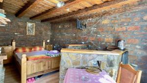 a room with a bedroom with a bed and a table at Apartmani Todorovic Ugore Vrdnik in Vrdnik