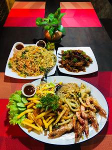 a table with four plates of food on it at Villa Mango in Negombo +4 photos