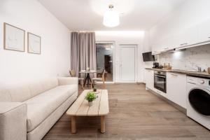 a living room with a couch and a table at Sinati Luxury Studios Laganas Zakynthos in Laganas