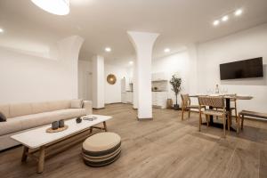 a living room with a couch and a table at Sinati Luxury Studios Laganas Zakynthos in Laganas