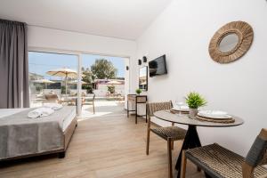 a living room with a table and a dining room at Sinati Luxury Studios Laganas Zakynthos in Laganas +43 photos